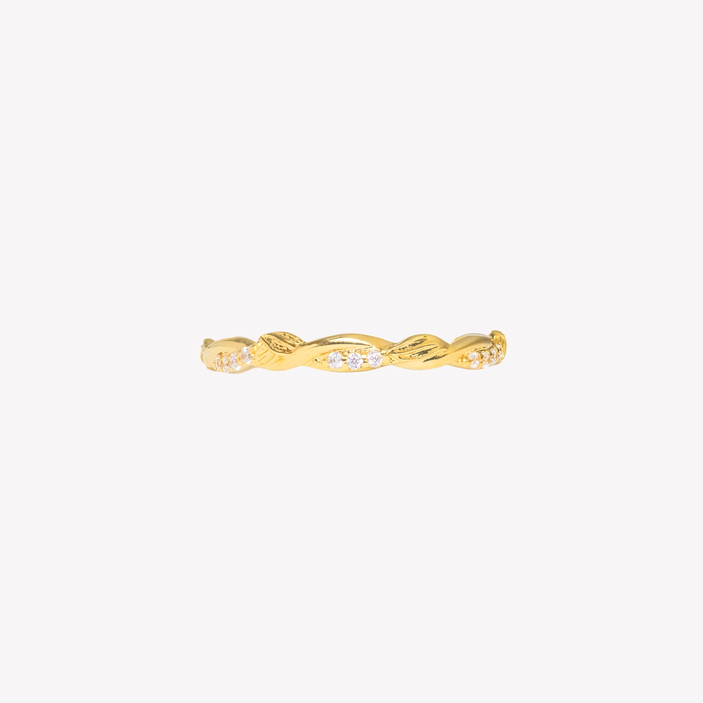 18k gold plated sacred vine band ring with sparkling cubic zirconias and delicate olive leaves intertwined on the band worn by a female christian jewelry model. 