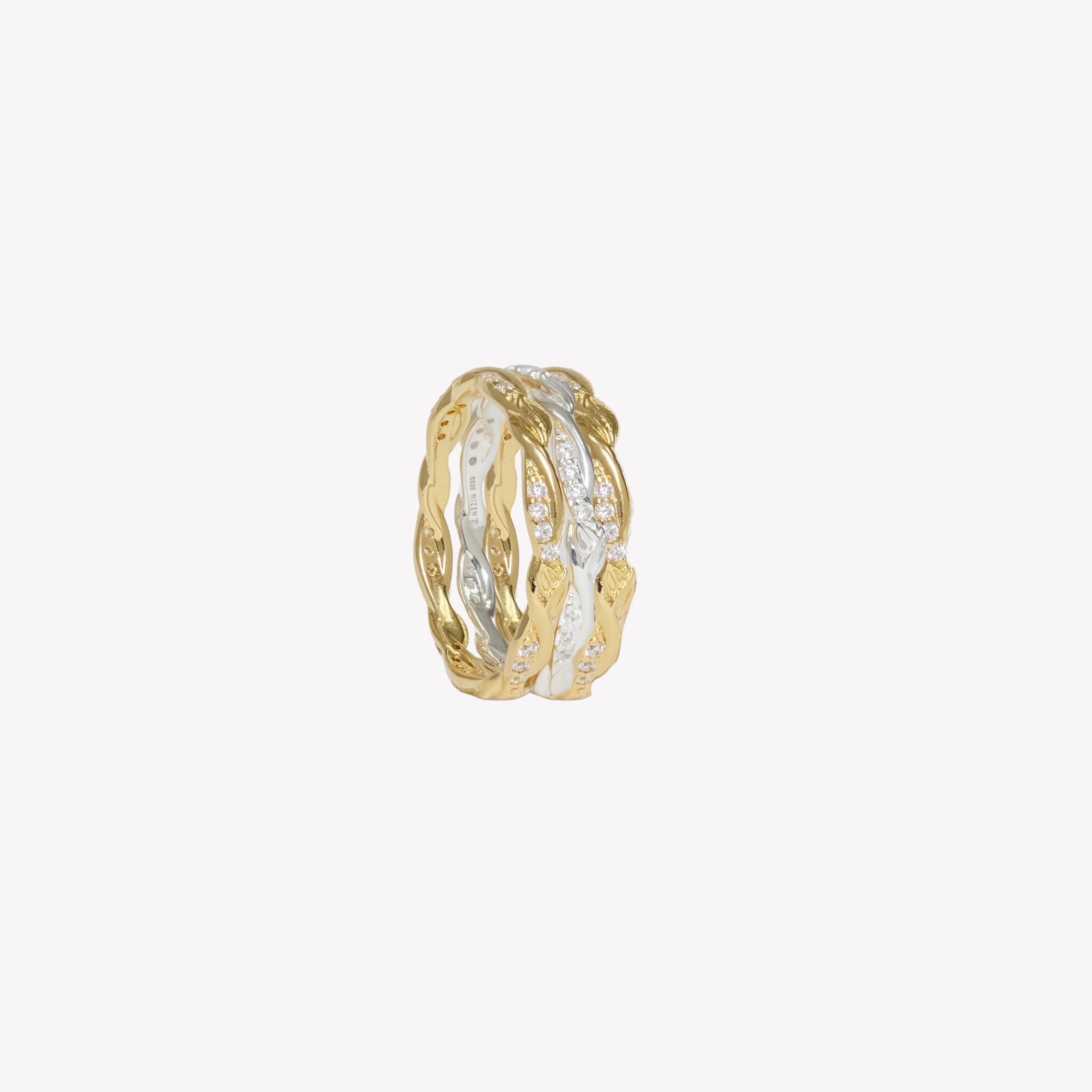 18k gold plated sacred vine band ring with sparkling cubic zirconias and delicate olive leaves intertwined on the band stacked with a sterling silver and additional gold band ring. 