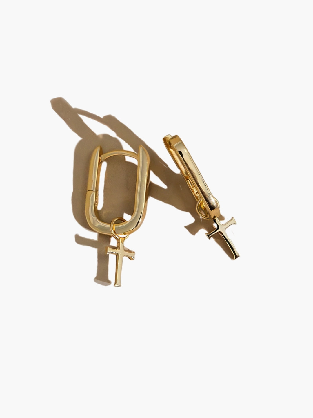 Sleek Gold U  Hoop Cross Earrings with the  Cross Dangling from the modern link shaped hoop by Rizen Jewelry. 