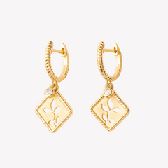 18k gold vermeil Olive Leaf Hoop Earrings feature a subtle matte finish, with an intricate rope borders along diamond shaped pendant, with delicate cubic zirconias dangling from the twisted rope like hoops are a perfect addition to the Rooted Collection by Rizen Jewelry. 