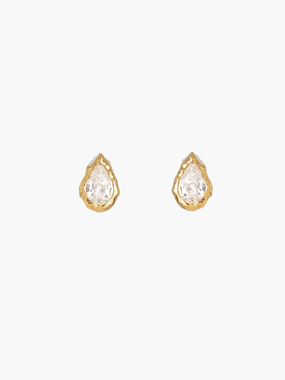 A pair of the Rizen Jewelry gold Solace Tear Stud Earrings. Feature teardrop shapped earrings with clear faceted simulated diamonds, nestled within a fluid hammered texture. 