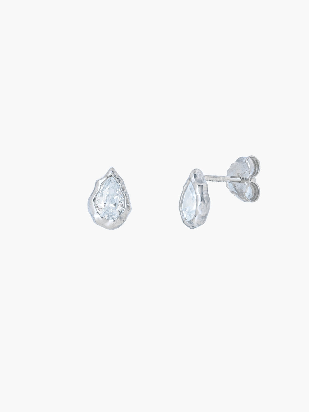 A pair of Rizen Jewelry Solace Tear Stud Earrings  in sterling silver stud.  They feature a tear drop shaped simulated diamond shown on a plain light gray background.