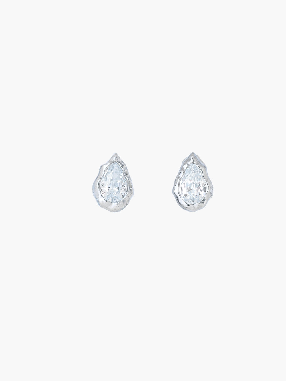A pair of Rizen Jewelry Solace Tear Stud Earrings  in sterling silver stud.  They feature a tear drop shaped simulated diamond shown on a plain light gray background.