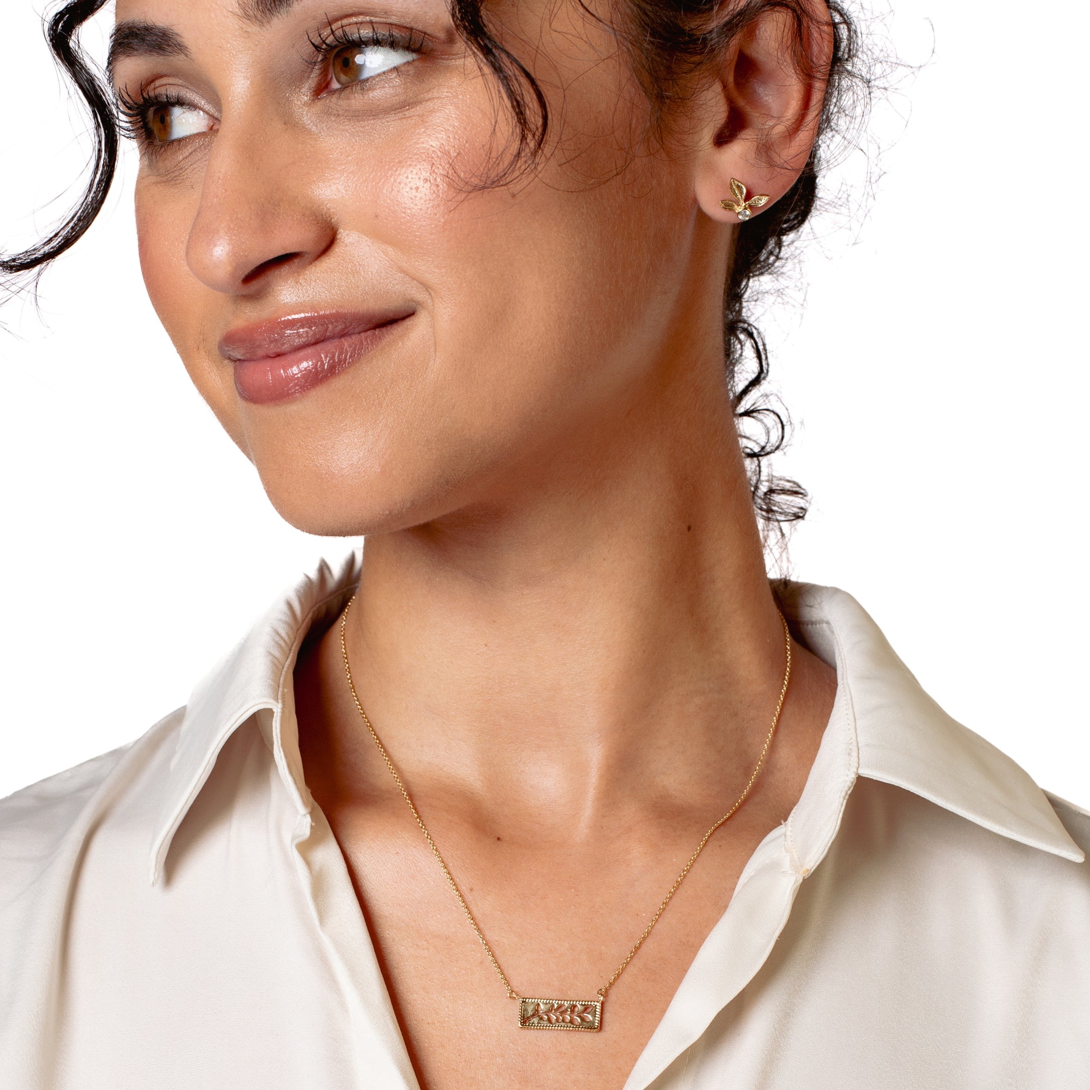 Serene Reverence Jewelry Set in 18k gold vermeil features the exquisite Olive Leaf Earrings and beautiful Branch Necklace from the Rooted Collection worn by Rizen Jewelry christian female jewelry model. 