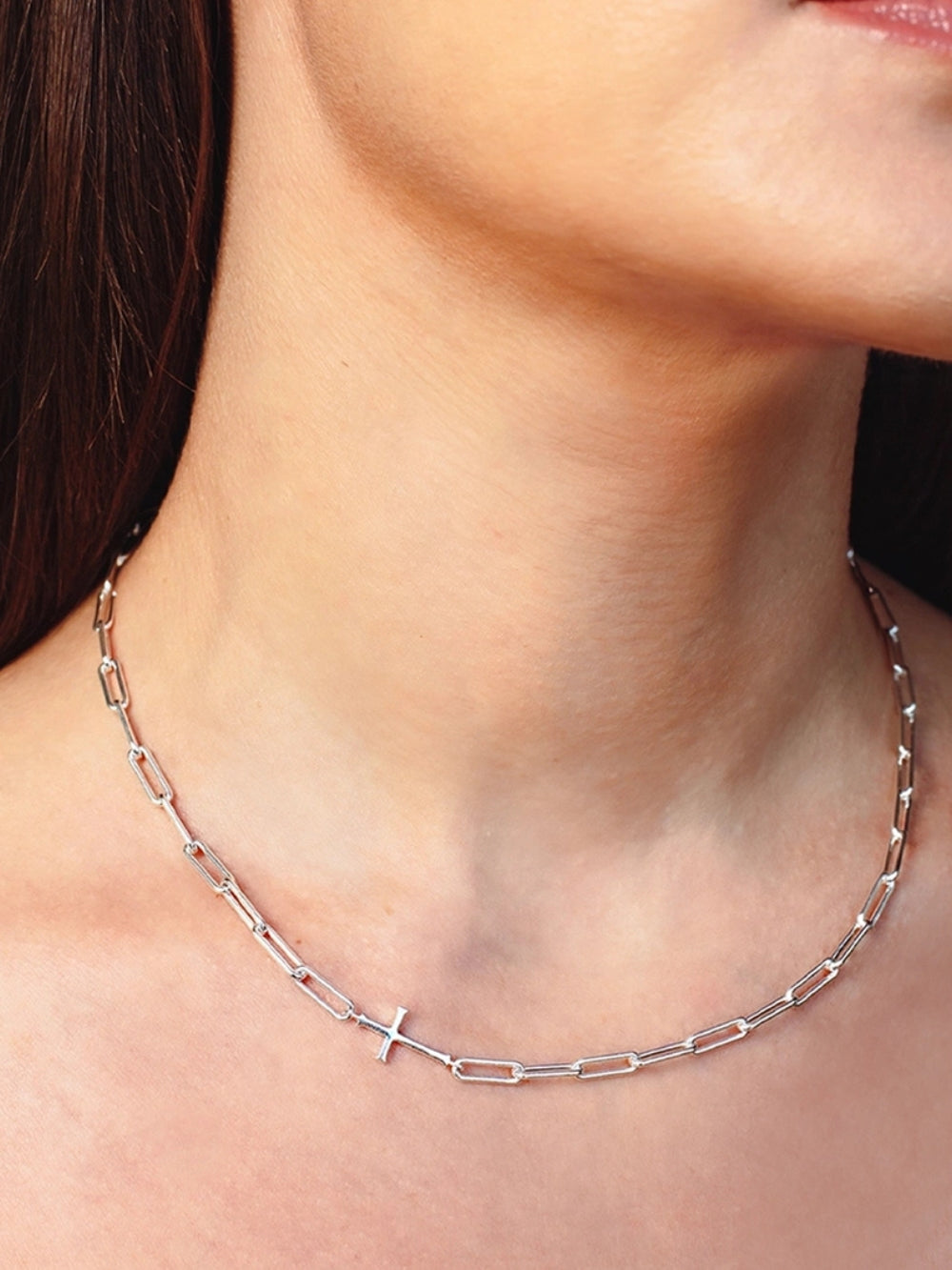 Women's Christian jewelry model wears the Silver Paper Clip Chain Breaker Cross Necklace in Sterling Silver by Rizen Jewelry. 