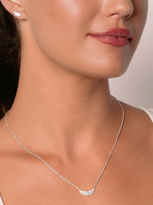 Women's Christian jewelry model is wearing the Divine wings mini necklace in sterling silver from the Insignia collection.  Inspirational gift for any occasion by Rizen Jewelry.