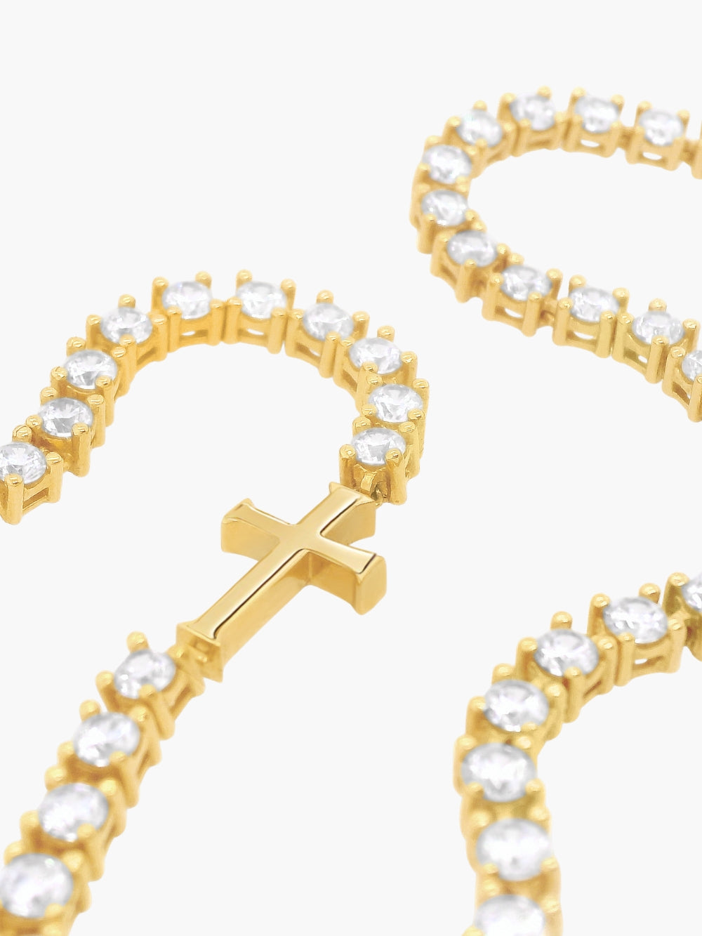 Up close look at the Luminous cross tennis necklace in 18k gold plated from the Calvary collection by Rizen Jewelry.