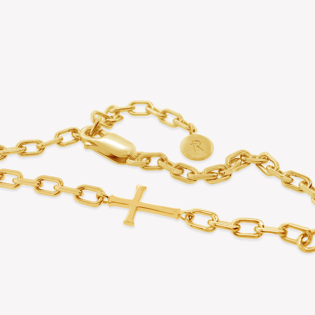 Close up of Mini Chain Breaker Cross Necklace in 18k gold vermeil from the calvary collection by Rizen Jewelry highlighting that the lobster clasp works on every link making it fully adjustable. 
