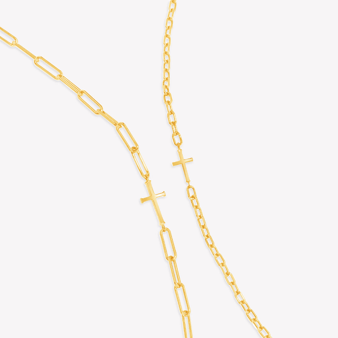 Mini Chain Breaker Cross Necklace in 18k gold vermeil from the calvary collection by Rizen Jewelry next to the original Chain Breaker Cross Necklace on the left.