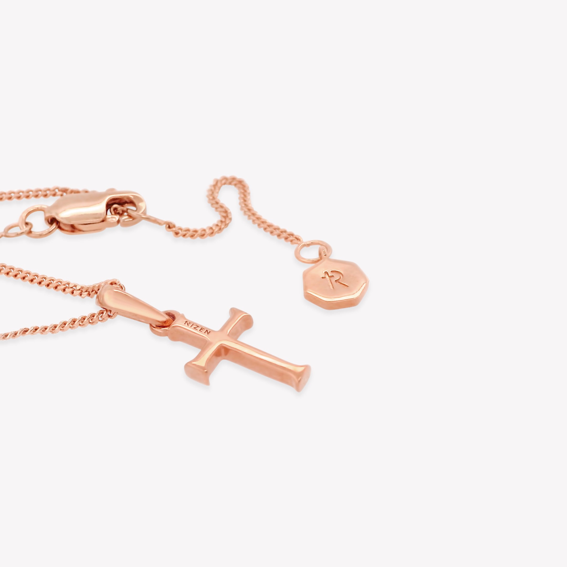 Rizen Jewelry 18k rose gold vermeil unisex cross pendant on a sleek adjustable curb chain. Perfect size for both adults and youth ages 8 years+.  Shows back of Cross with RIZEN engraved along top of cross. 