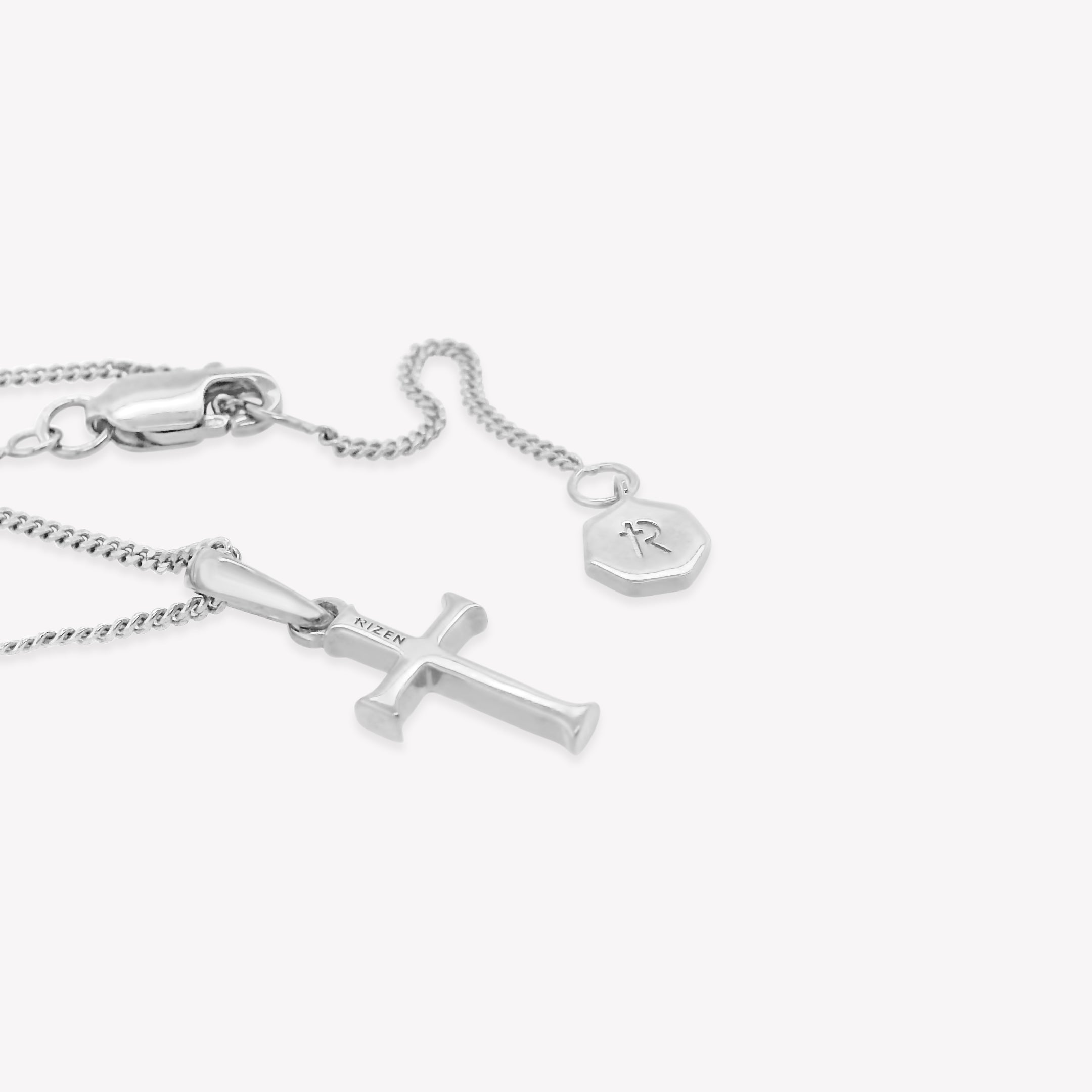 Rizen Jewelry sterling silver unisex cross pendant on a sleek adjustable curb chain. Perfect size for both adults and youth ages 8 years+. The backside of the pendant is engraved RIZEN. 