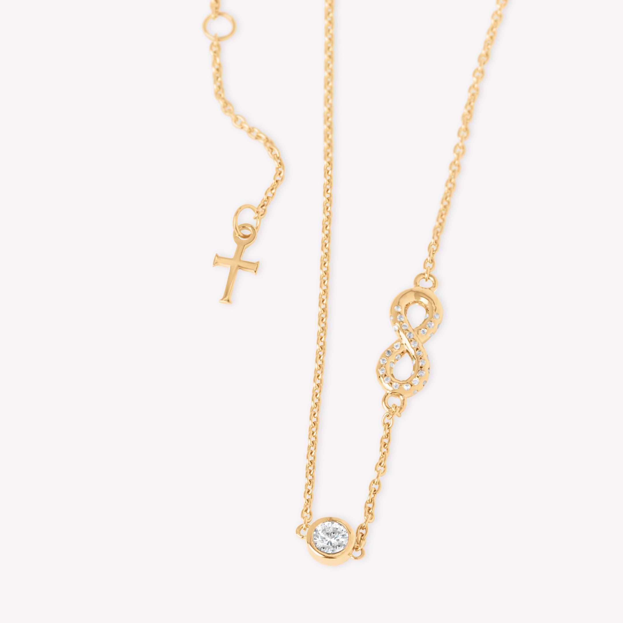 radiant 18k gold vermeil Infinite Hope necklace showcases a pavé zirconia ichthys nestled within an infinity pendant, elegantly crowned by a 5mm solitaire centerpiece with the Rizen cross pendant tag designed by Rizen Jewelry. 