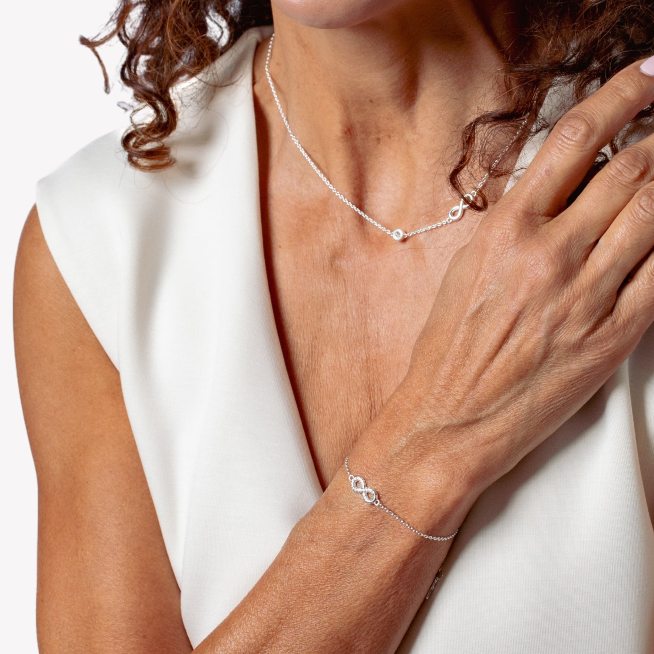 Sterling silver Infinite Hope jewelry gift set featuring the matching necklace and bracelet modeled by a Christian Mom. 