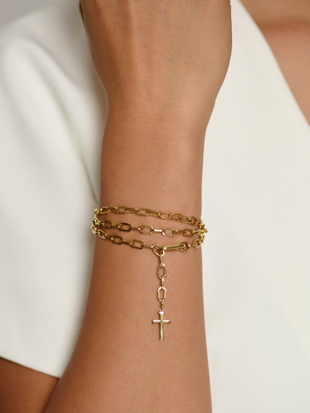Women's Christian Jewelry model wears the Chain Breaker Convertible Wrap Cross  Necklace as a bracelet. 