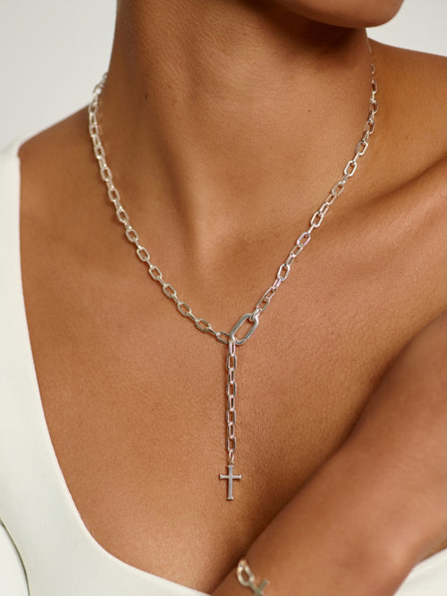 Women's Christian Jewelry model wearing the Sterling silver versatile lariat Y-chain cross necklace by Rizen Jewelry. This elegant design wraps around the neck or wrist to create a sleek, refined expression of faith. 