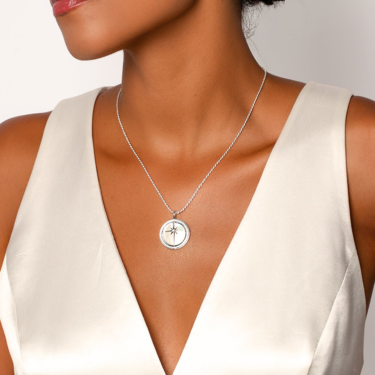 Womans christian jewelry model wearing the sterling silver Ture Direction Compass necklace from the Insignia Collection by Rizen Jewelry. 