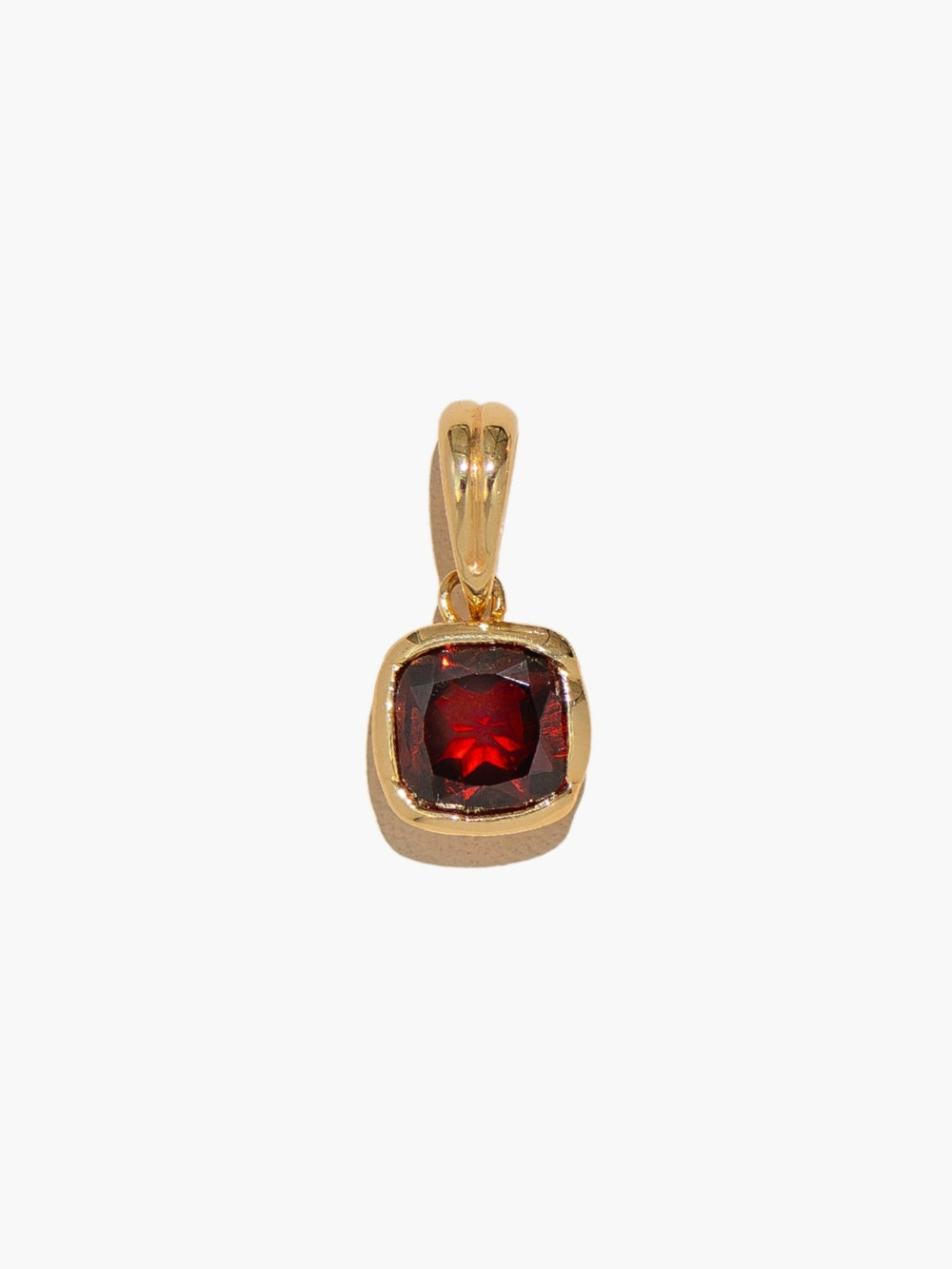 Close-up of Garnet red fully known prayer pendant in 18k gold finish. 