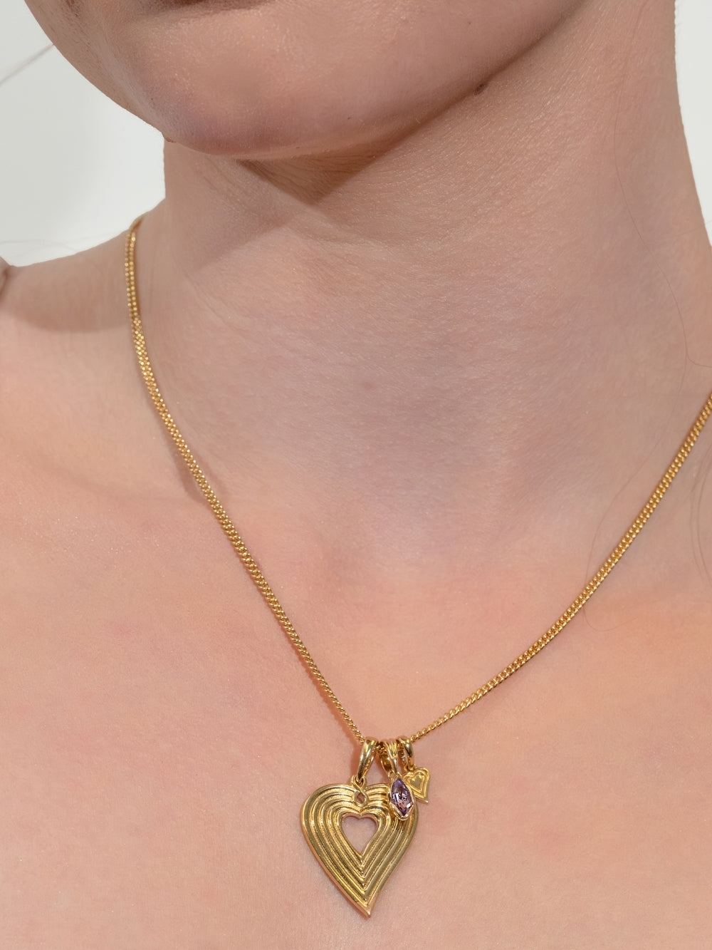 Women's Christian jewelry model wears the Light Amethyst Fully Known Prayer Pendant layered with the Emanate Love Heart Necklace by Rizen Jewelry 