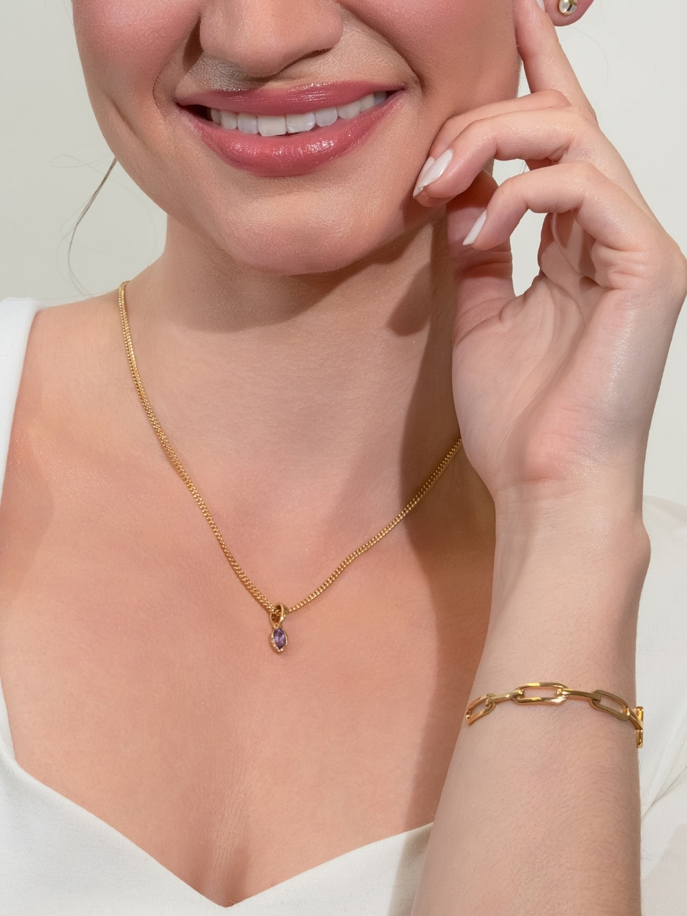 Women's Christian Jewelry model wears the Light Amethyst Fully Known Prayer Pendant by Rizen Jewelry. A luminous marquis cut light amethyst pendant, reflecting honor, peace, royalty, and the sweet heart of February, cradled gently in refined 18k gold plating over sterling silver. Personalize your Rizen Jewelry with a Fully Known Prayer Pendant. 