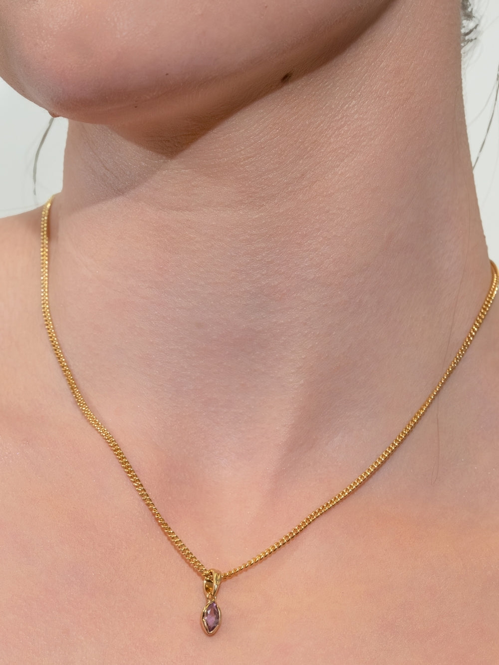 Women's Christian jewelry model wearing the Light Amethyst Fully Known Prayer Pendant on a curb chain by Rizen Jewelry. 