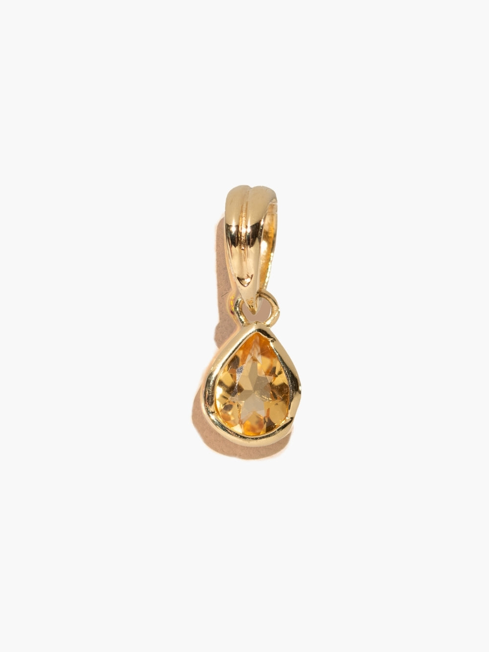  A pear-cut light citrine stone is cradled in a 18k gold finished setting. The pendant symbolizes wisdom, truth, guidance, and the month of November by Rizen Jewelry. 
