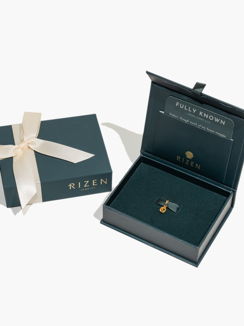  A pear-cut light citrine stone is cradled in a 18k gold finished setting. The pendant symbolizes wisdom, truth, guidance, and the month of November by Rizen Jewelry featured in a gift box. 