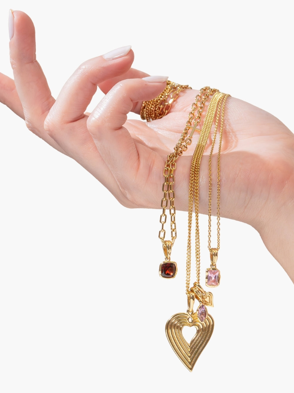 Women's Christian jewelry model holding fully known prayer pendants featured on Rizen Jewelry necklaces.