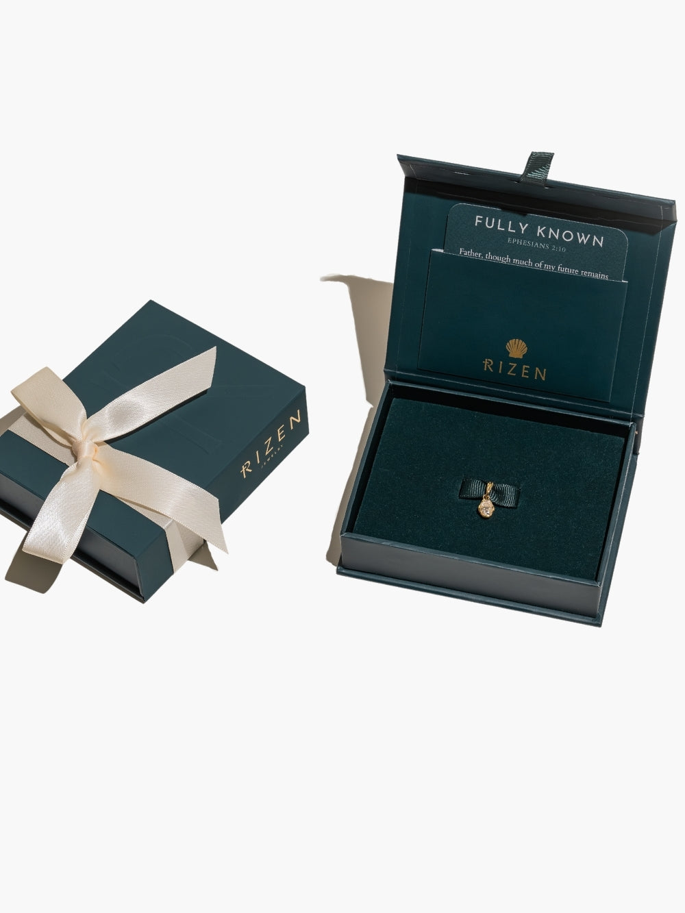 Ready to gift with the beautiful packaging featuring the white sapphire fully known prayer pendant from Rizen Jewelry in gold.