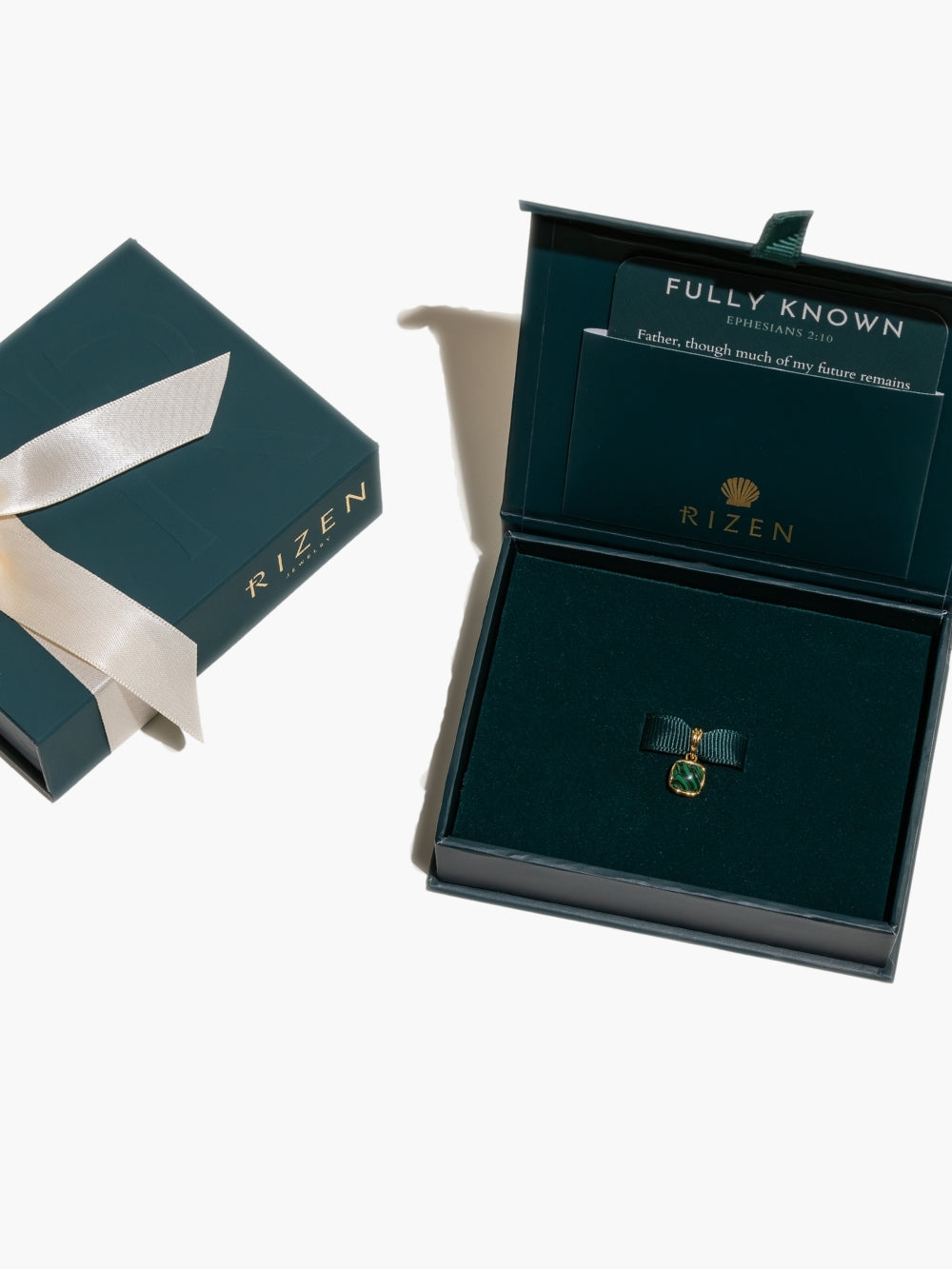 The Malachite Fully Known Prayer Pendant by Rizen Jewelry is boxed up and ready to be gifted. 