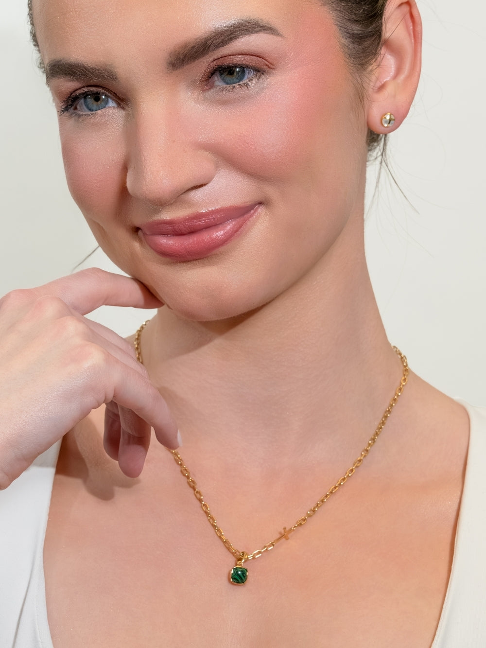 Women's Christian jewelry model wearing the Malachite Fully Known Prayer Pendant by Rizen Jewelry features a distinctive square cabochon cut malachite pendant, reflecting intentionality, growth, and the stone for May, cradled gently in refined 18k gold plating over sterling silver. 