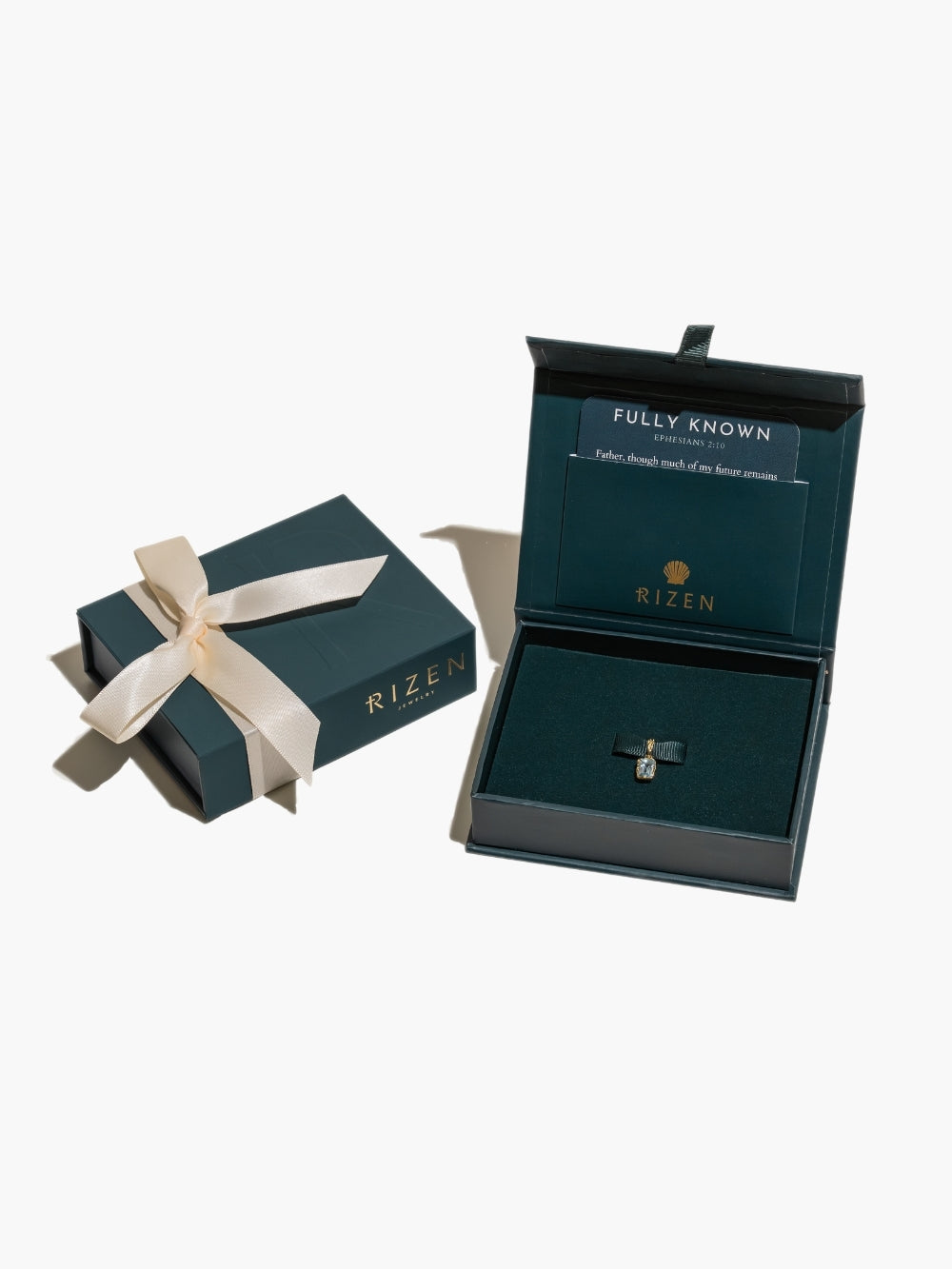 Sky Blue Topaz Fully Known Prayer Pendant featured in the Rizen Jewelry packaging that's ready to gift.