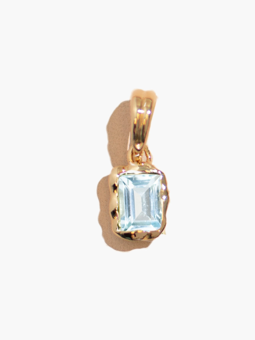 Close-up of the Sky Blue Topaz Fully Known Prayer Pendant in gold finish by Rizen Jewelry. 