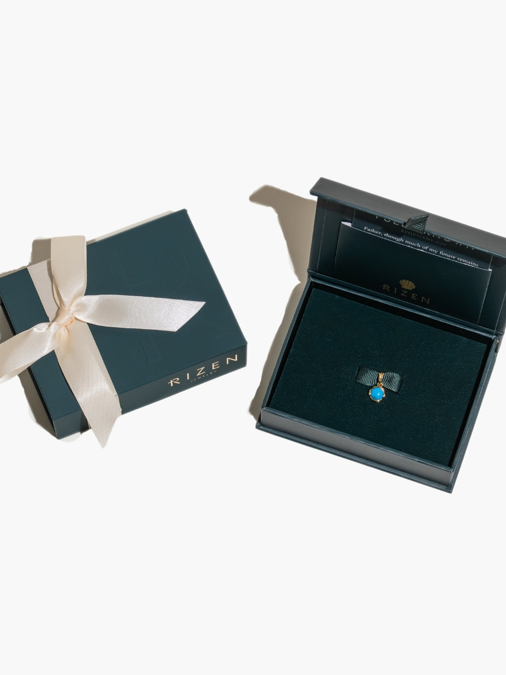 Ready to gift the Turquoise Fully Known Prayer Pendant by Rizen Jewelry features a round cabochon turquoise stone is cradled in 18k gold plating over sterling silver setting. The pendant symbolizes Restoration, Leadership, Favor, and the month of December.