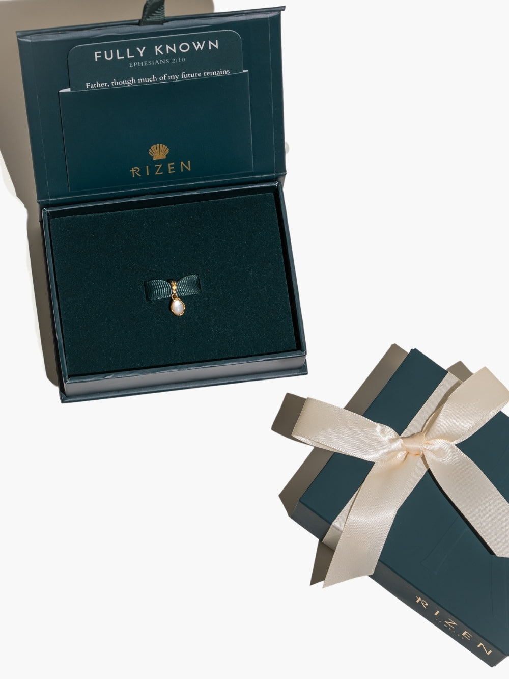 Beautifully packaged in a gift box. The White Mother of Pearl Fully Known Prayer Pendant by Rizen Jewelry features an  oval cabochon Mother of Pearl stone  cradled in 18k gold plating over sterling silver. The pendant symbolizes Transformation, Sacred, Beauty, and the month of June.