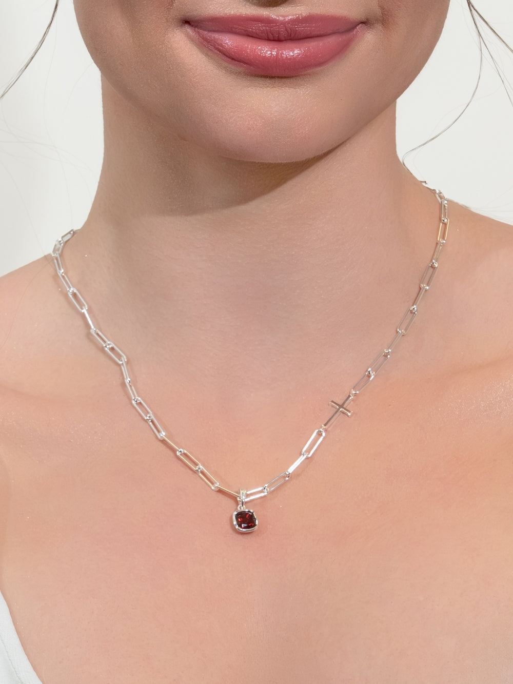 Female Christian jewelry model wearing the silver chain breaker necklace with the added garnet fully known prayer pendant.