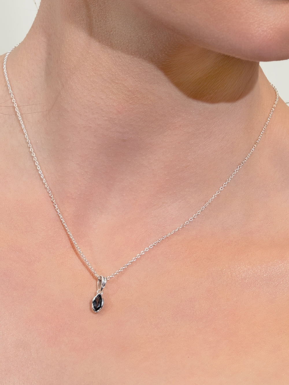 Female Christian jewelry model wears the London Blue Topaz Fully Known Prayer Pendant on a sleek silver cable chain by Rizen Jewelry. 