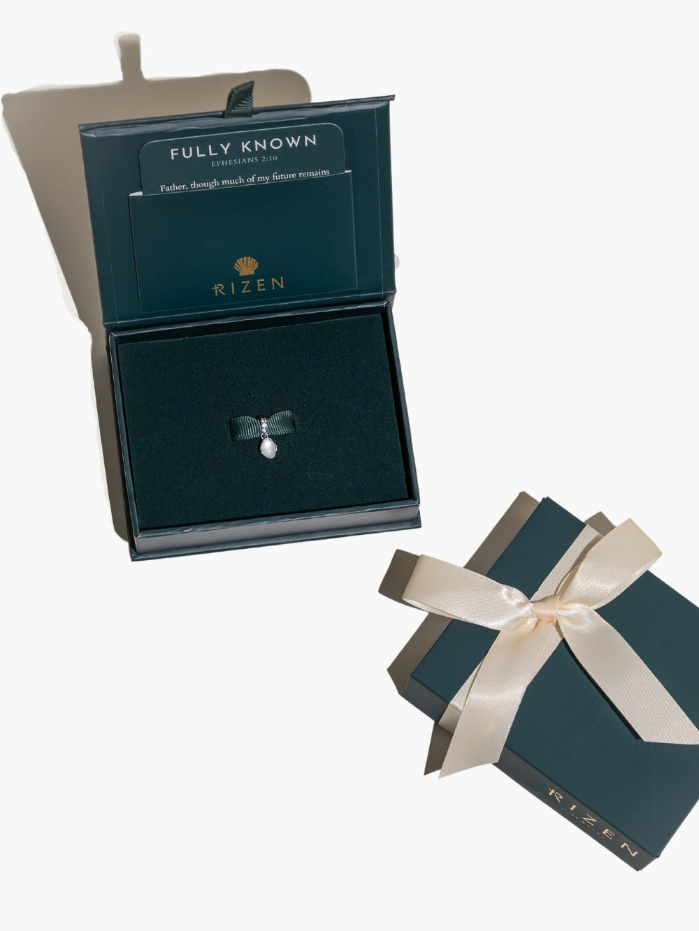 All packaged up and ready to gift the White Mother of Pearl Fully Known Prayer Pendant by Rizen Jewelry features an oval cabochon Mother of Pearl stone  cradled in sterling silver setting. The pendant symbolizes Transformation, Sacred, Beauty, and the month of June.