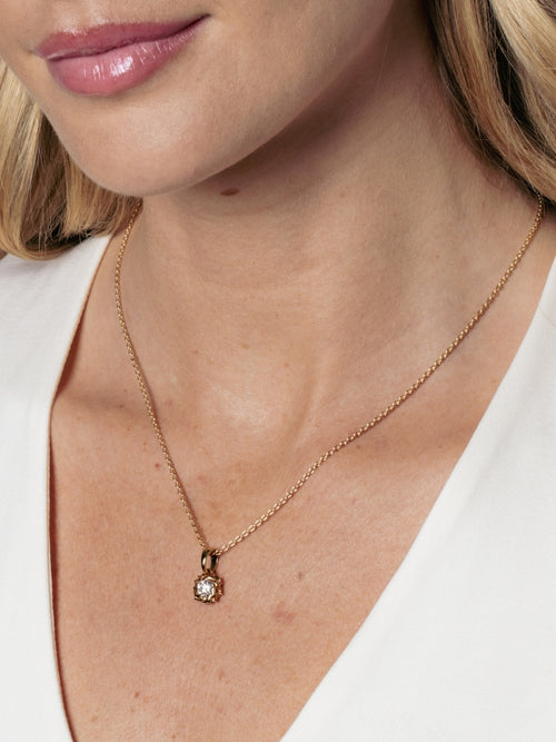 Close up of a Christian woman wearing the Rizen Jewelry Crown of Thorns pendant on a delicate cable chain. 