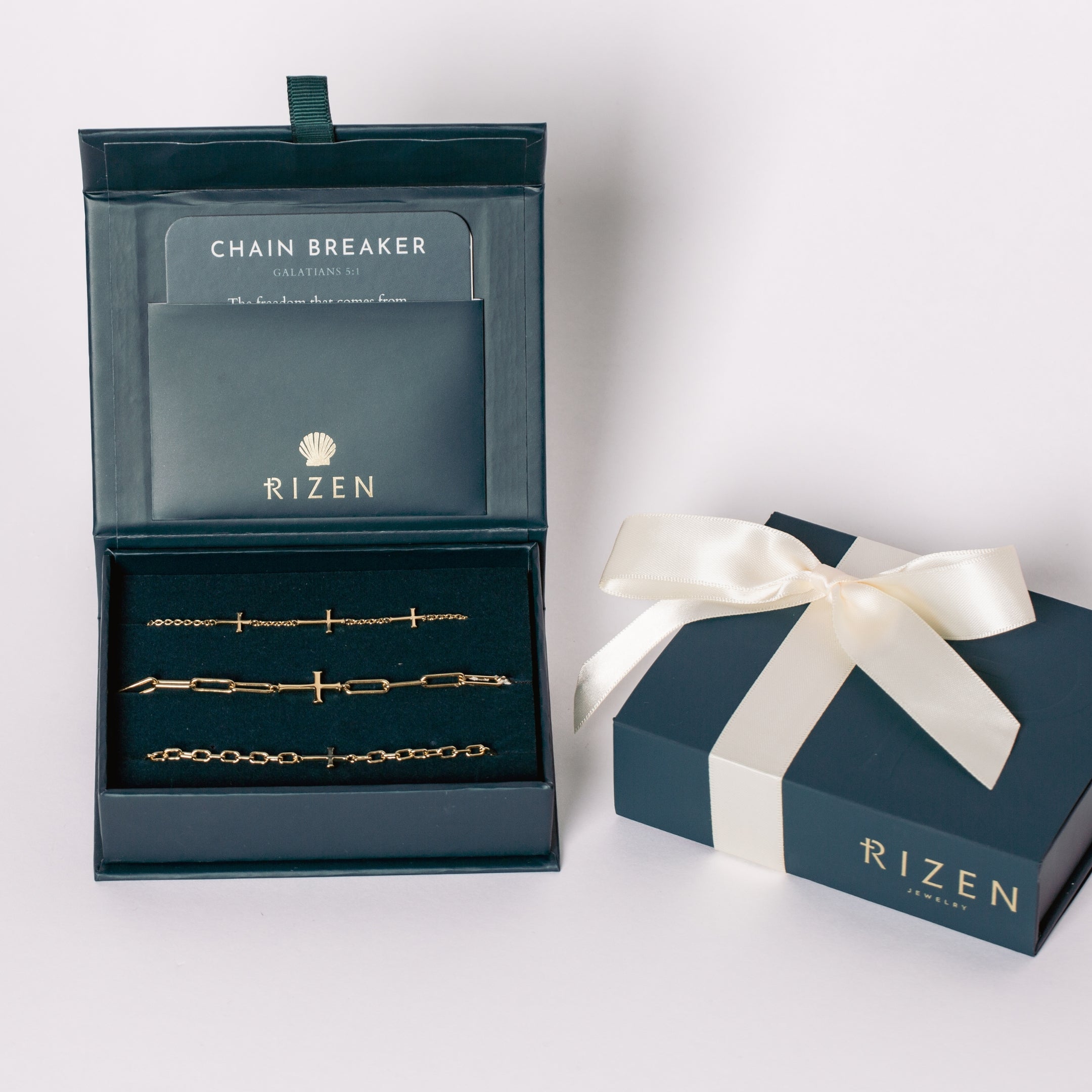A three-piece 18k gold-plated cross bracelet set featuring a Calvary cross bracelet and two additional chain breaker cross bracelets in the Rizen Jewelry Gift Box. 