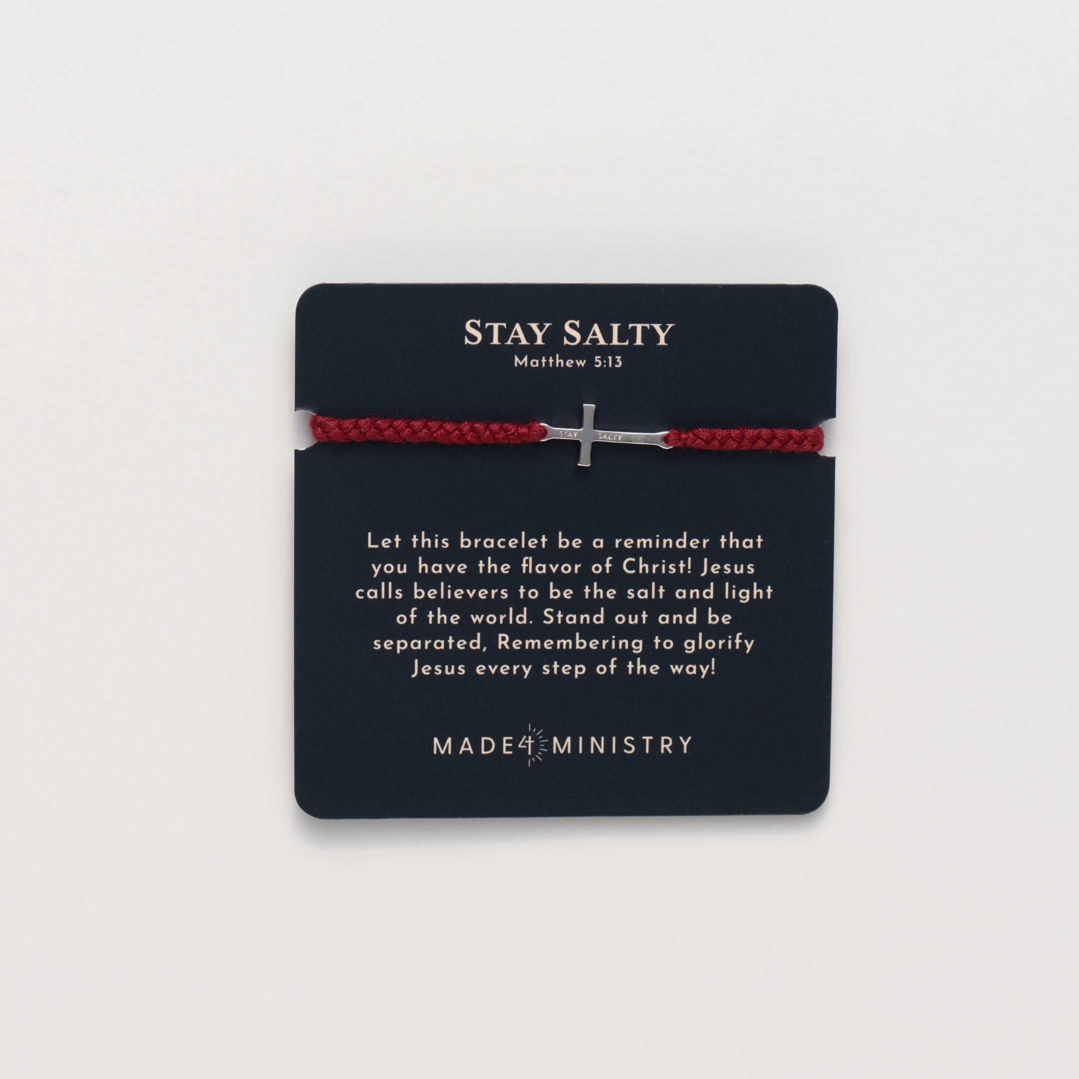 Christian silver cross friendship bracelet engraved "STAY SALTY" hand braided garnet red cotton cords by Rizen Jewelry Made 4 Ministries collection. Featured on a Devotion Card next to the mini scripture card. 