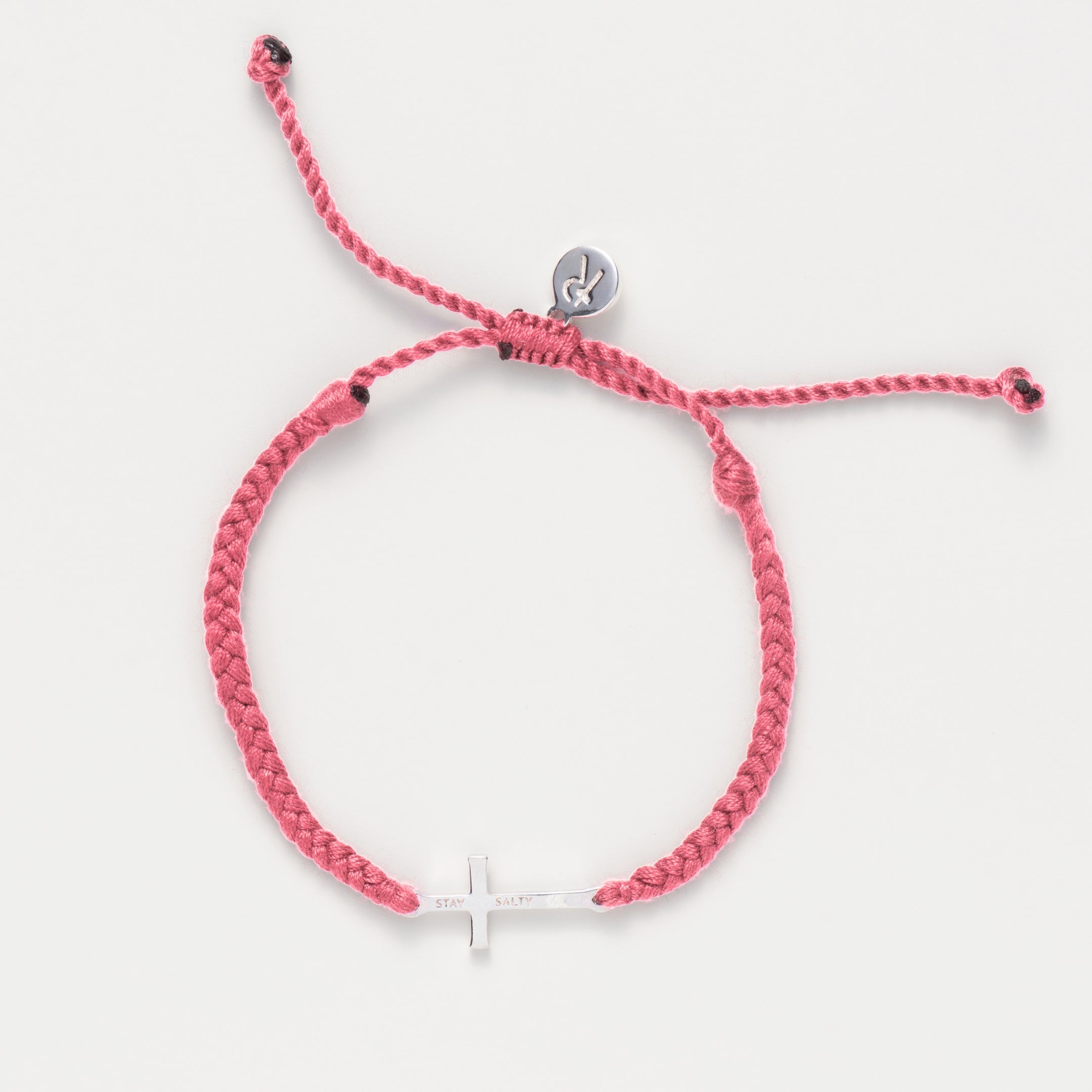 Cross bracelet engraved STAY SALTY set on a naturally dyed pink dusty rose hand-braided, cotton cord friendship bracelet with a gold or sterling silver finish from the Made4Ministry Collection by Rizen Jewelry. 