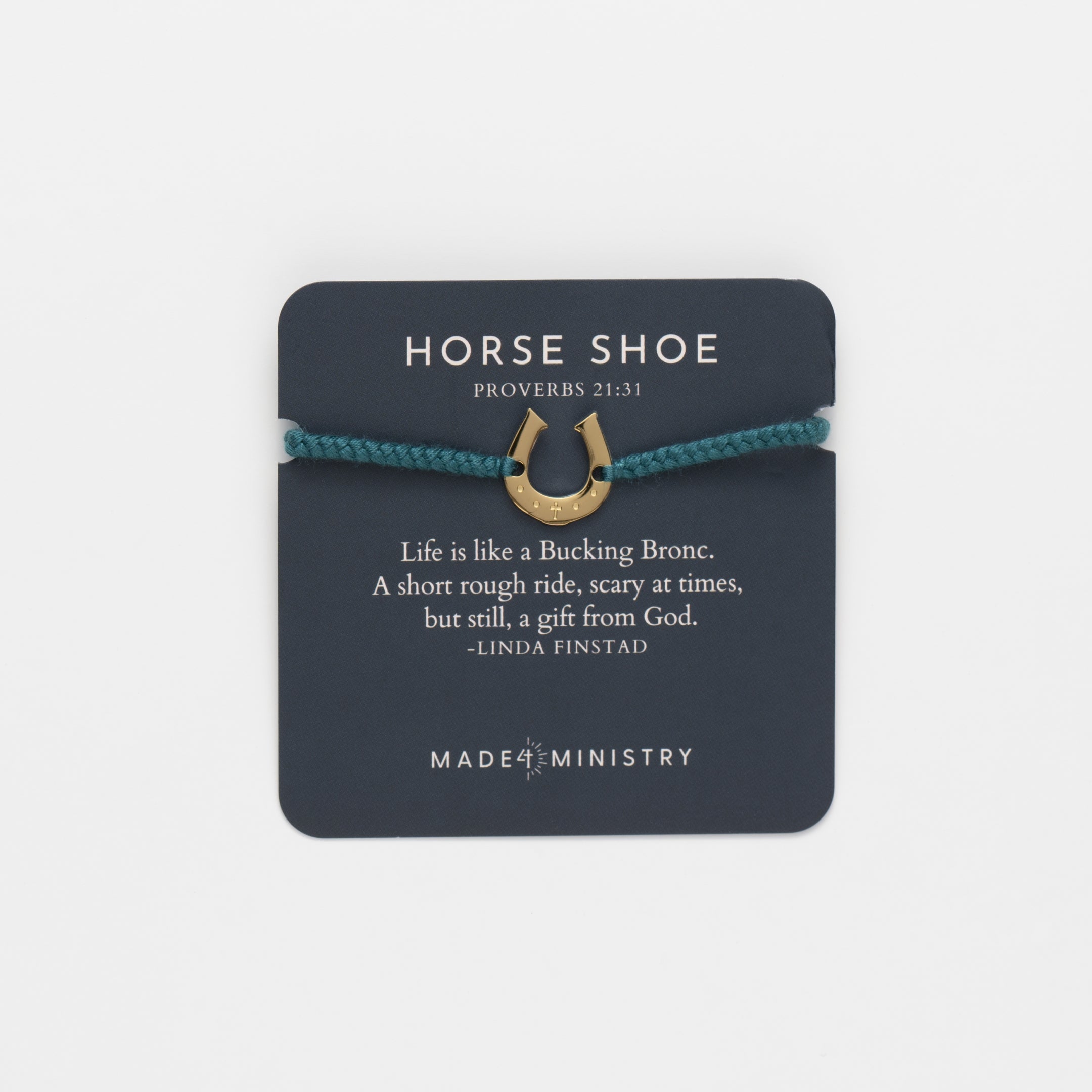 Horseshoe bracelet engraved with a cross set on a naturally dyed azure blue hand-braided, cotton cord friendship bracelet. Available in 18k Gold and Sterling Silver finish. Featured on a Devotion card with a mini scripture card from the Made4Ministry Collection by Rizen Jewelry.