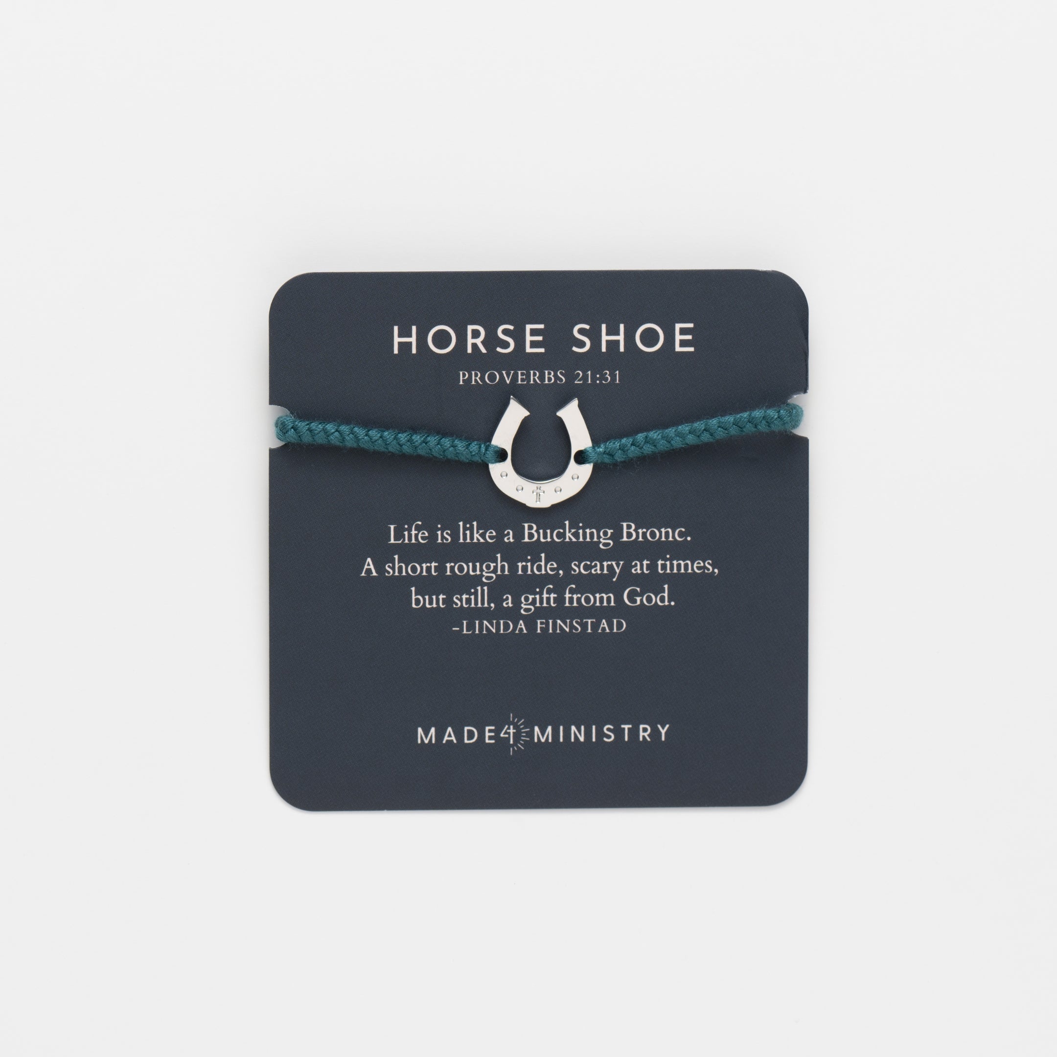 Horseshoe bracelet engraved with a cross set on a naturally dyed azure blue hand-braided, cotton cord friendship bracelet. Available in 18k Gold and Sterling Silver finish. Featured on a Devotion card from the Made4Ministry Collection by Rizen Jewelry.