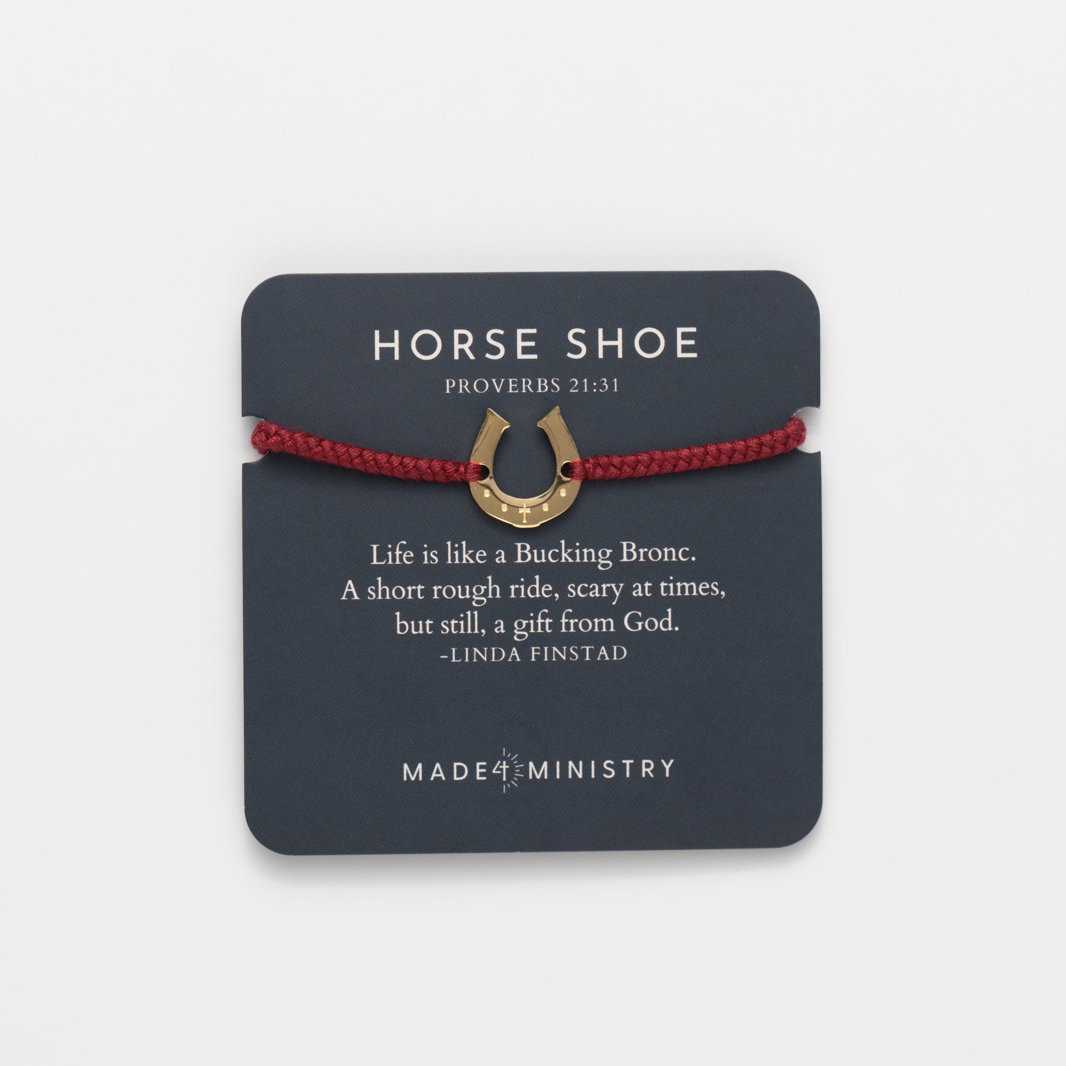 Horseshoe bracelet engraved with a cross set on a naturally dyed garnet red hand-braided, cotton cord friendship bracelet. Available in 18k Gold and Sterling Silver finish. Designed by Rizen Jewelry for the Made4Ministry Collection. Featured on a Devotion Card
