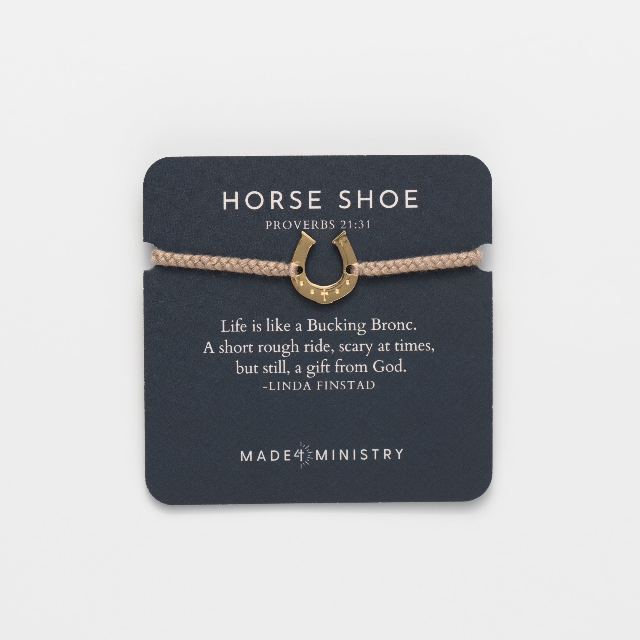 Horseshoe bracelet engraved with a cross set on a naturally dyed khaki hand-braided, cotton cord friendship bracelet. Available in 18k Gold and Sterling Silver finish. Featured on a Devotion card from the Made4Ministry Collection by Rizen Jewelry.