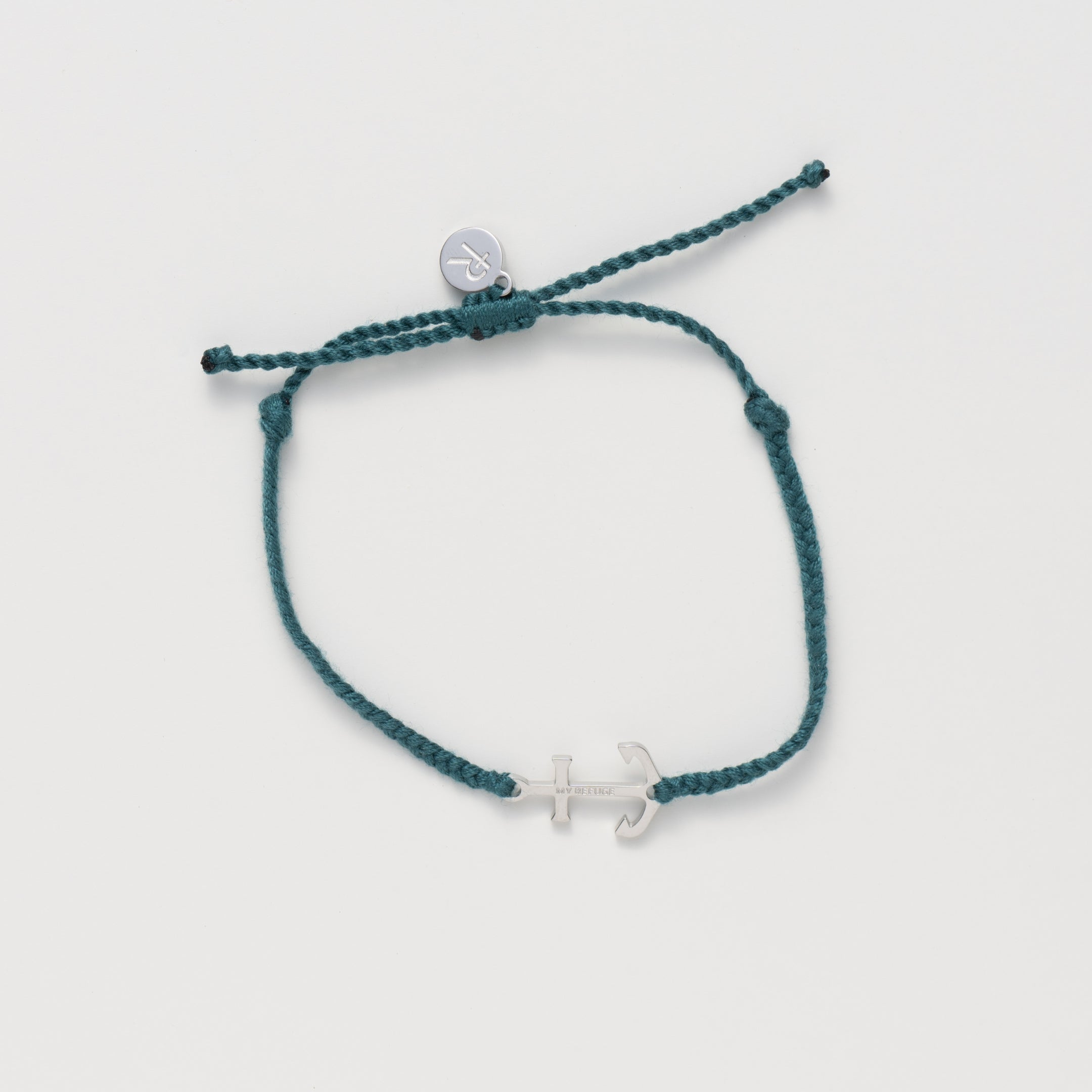 Classic nautical anchor bracelet, delicately engraved with the inscription “MY REFUGE,” hand-braided from naturally dyed azure blue cotton cord. Available in 18k gold or sterling silver finish from the Made4Ministry Collection by Rizen Jewelry. 