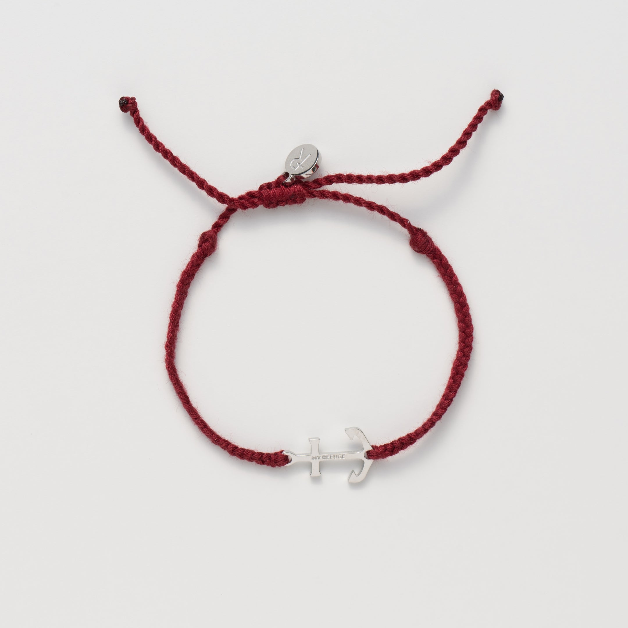 Classic nautical anchor bracelet, delicately engraved with the inscription “MY REFUGE,” hand-braided from naturally dyed garnet red cotton cord. Available in 18k gold or sterling silver finish from the Made4Ministry Collection by Rizen Jewelry. 