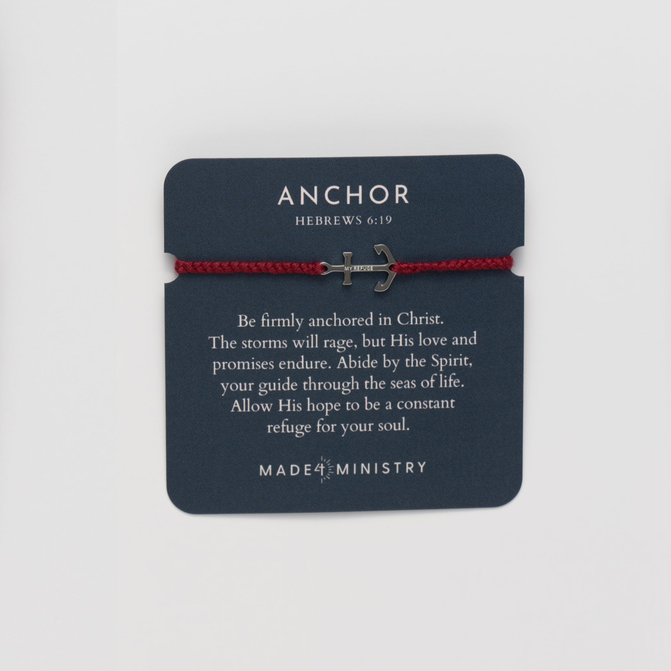 Inspirational devotion card features the classic nautical anchor bracelet, delicately engraved with the inscription “MY REFUGE,” hand-braided from naturally dyed garnet red cotton cord. Available in 18k gold or sterling silver finish from the Made4Ministry Collection by Rizen Jewelry. 