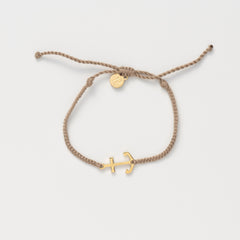 Gold anchor set on a khaki friendship bracelet with the engraving MY REFUGE from the Made4Ministry collection by Rizen Jewelry.