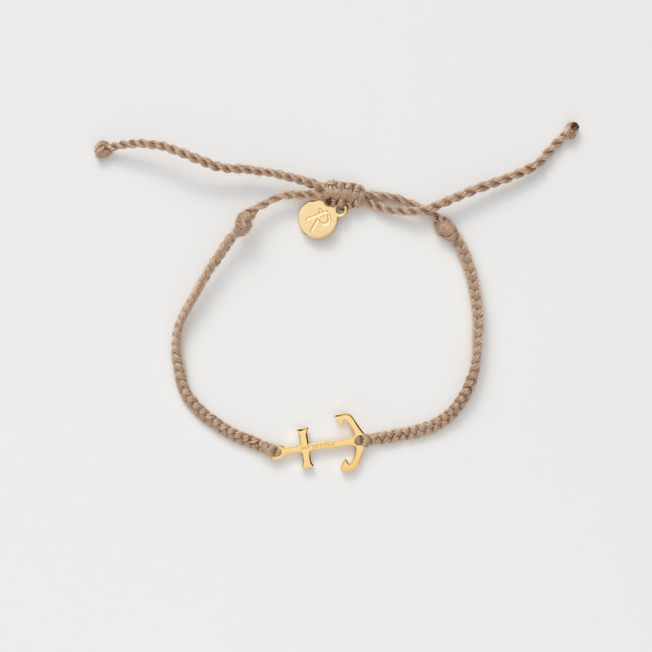 Gold anchor set on a khaki friendship bracelet with the engraving MY REFUGE from the Made4Ministry collection by Rizen Jewelry.